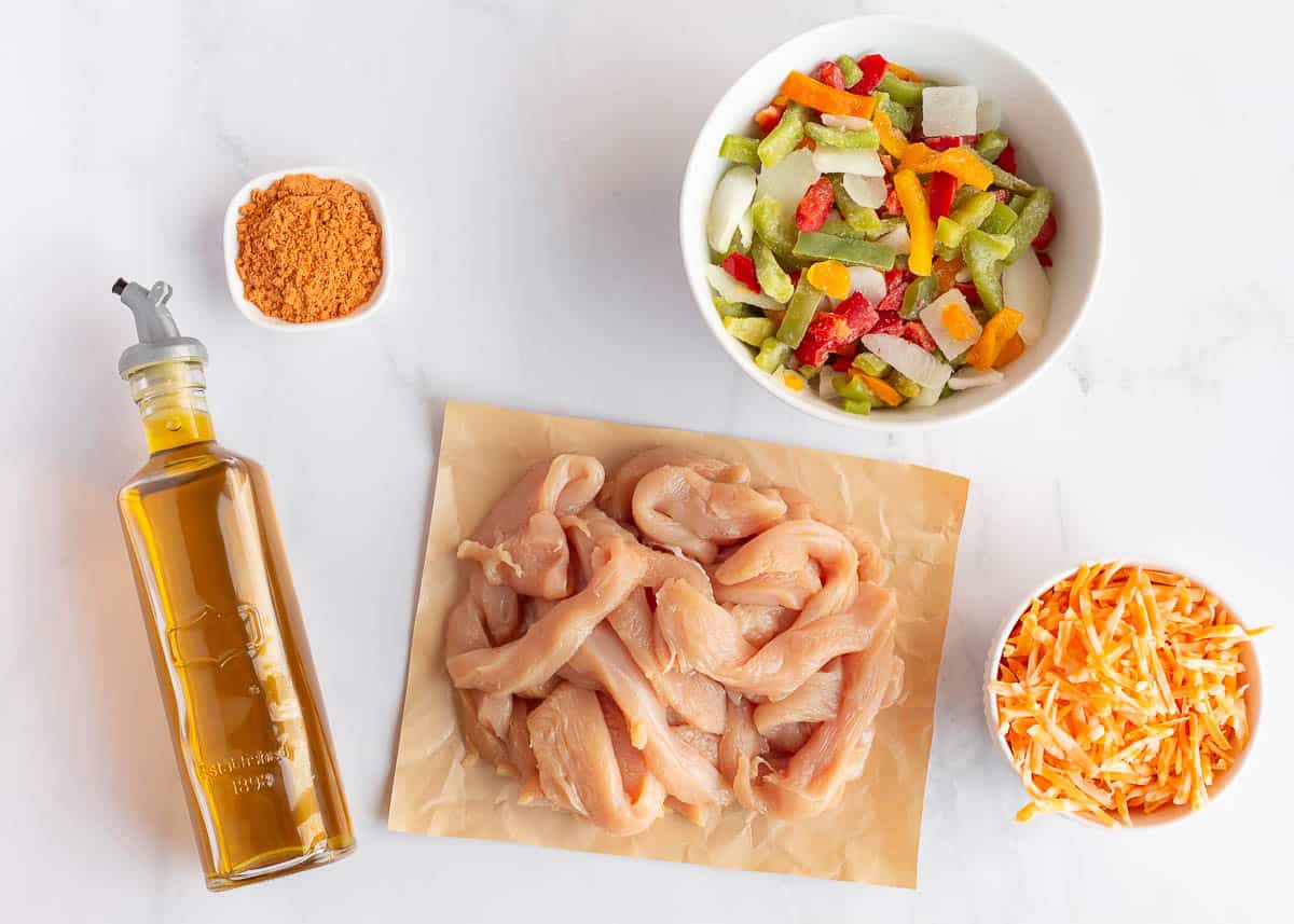 Chicken fajita casserole ingredients on the counter.