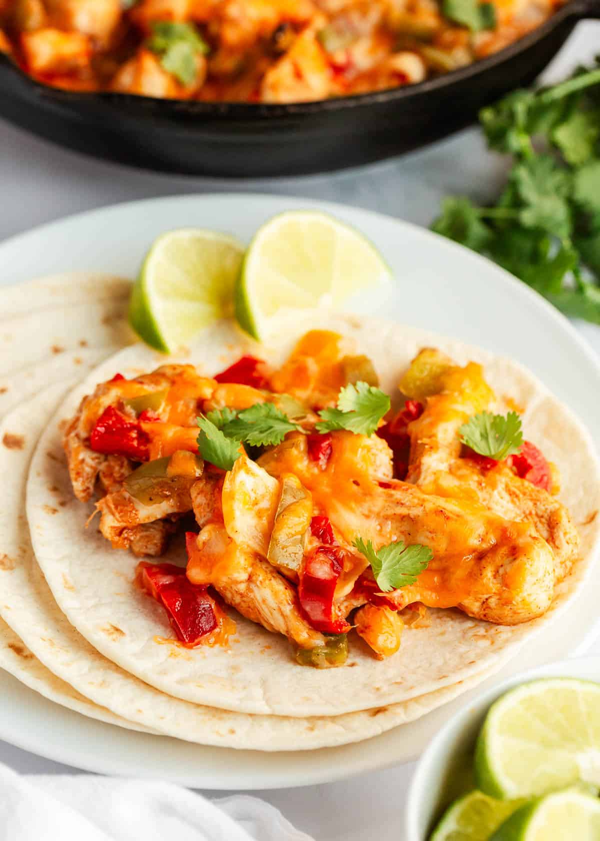 Chicken fajita casserole on a tortilla.