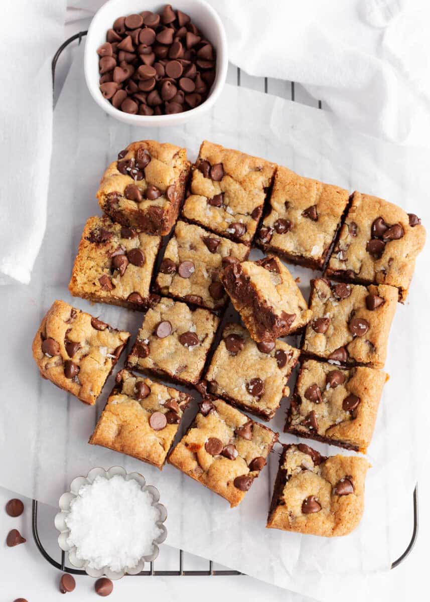 Chocolate chip cookie bars on a counter cut into squares.