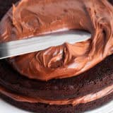 Spreading frosting on chocolate cake.