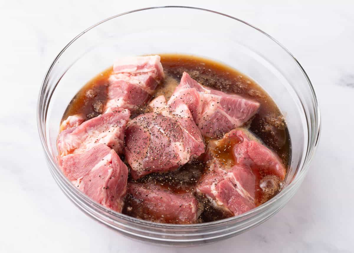 Boneless pork marinating in a bowl.