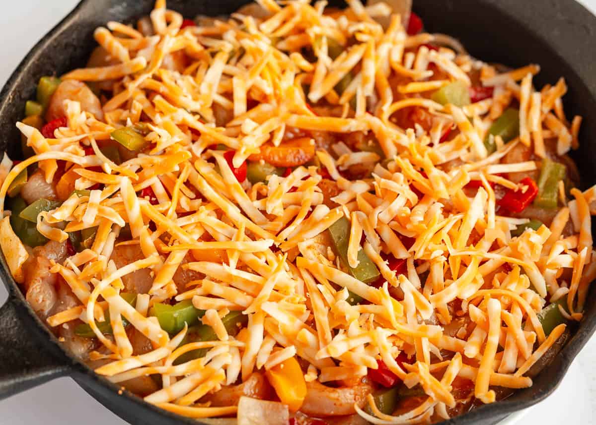 Chicken fajita casserole in a skillet.