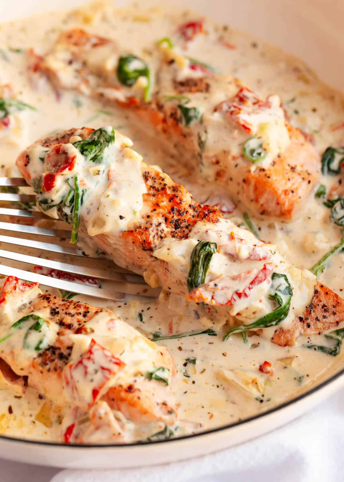 Tuscan salmon in a skillet.