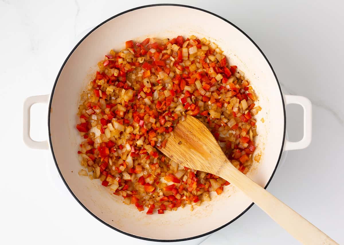 Vegetables being sauteed in a skillet.