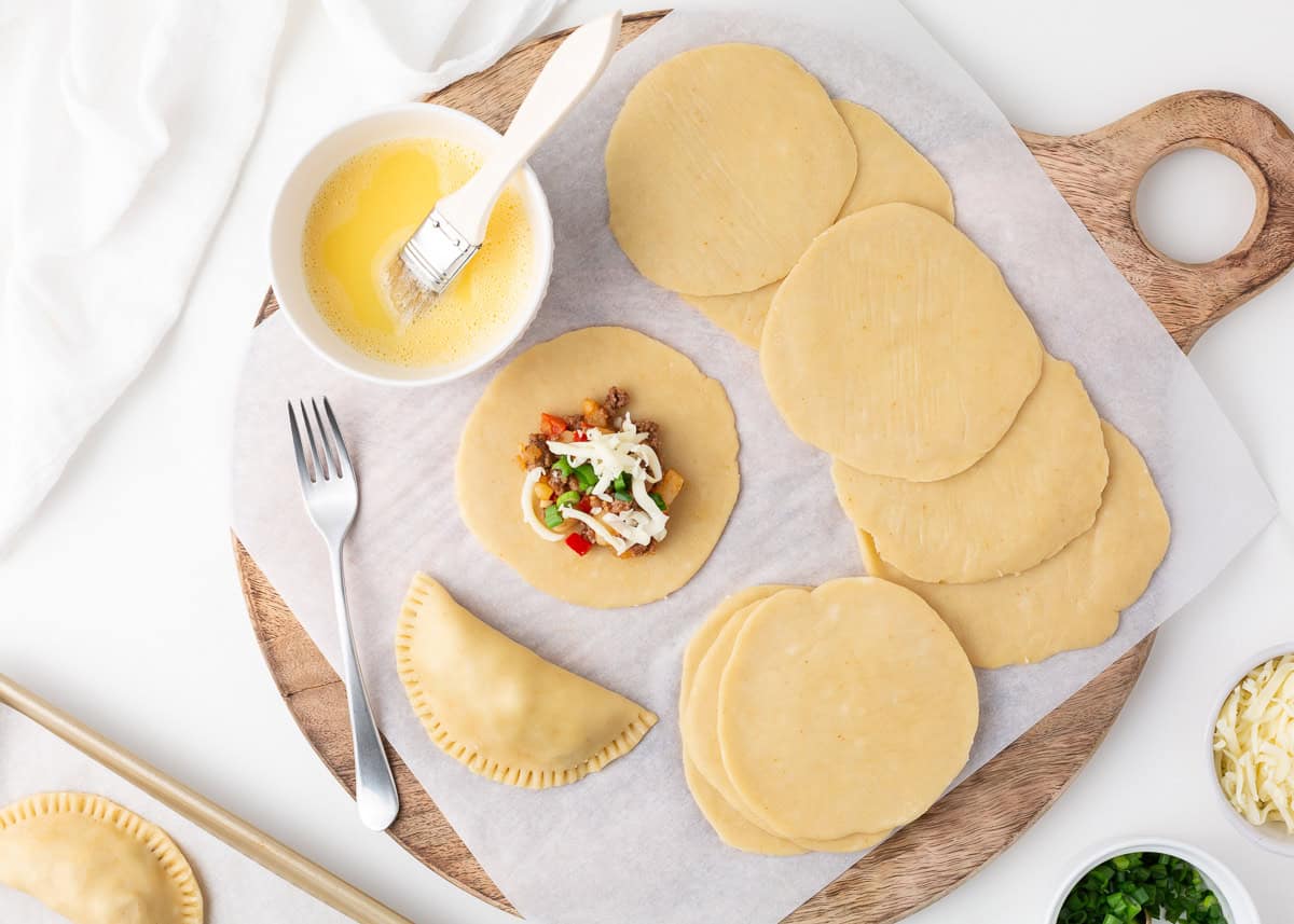 Assembling a beef empanada.