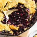 Blueberry dump cake with serving spoon.