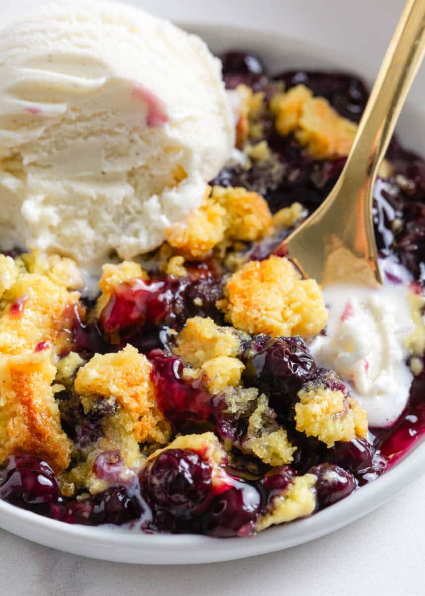 Blueberry dump cake with a scoop of ice cream.