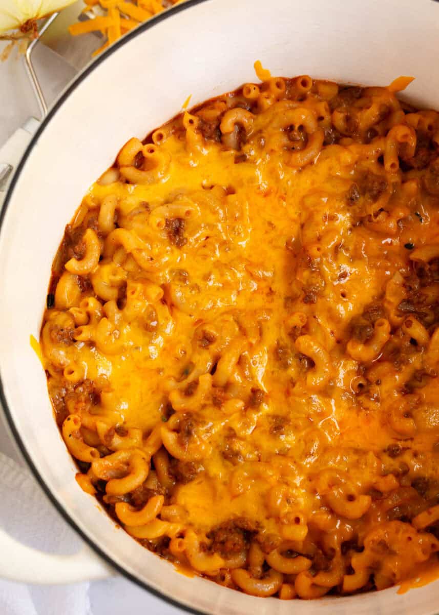 Cheeseburger casserole in a white pot.