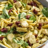 Chicken pesto pasta in a large skillet.