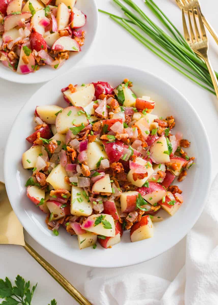 German potato salad in a white bowl.