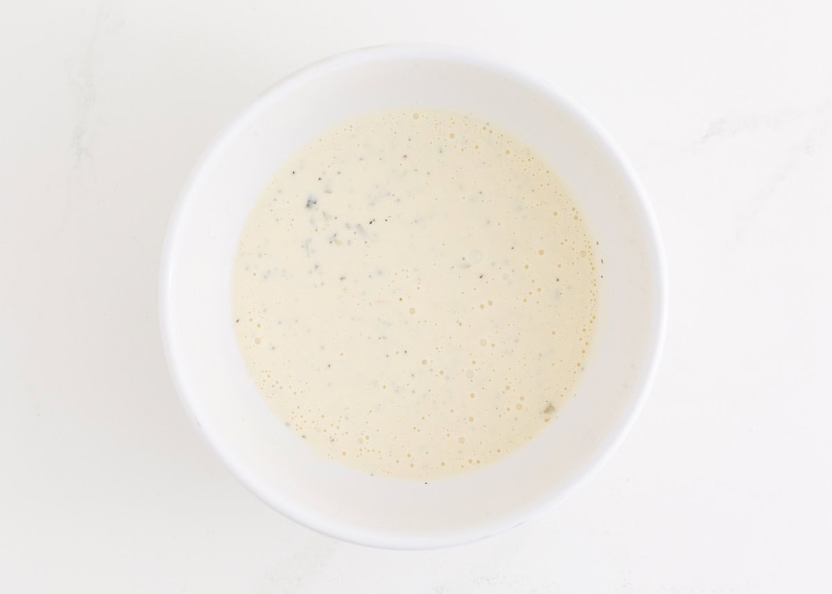 Creamy macaroni salad dressing in a bowl.