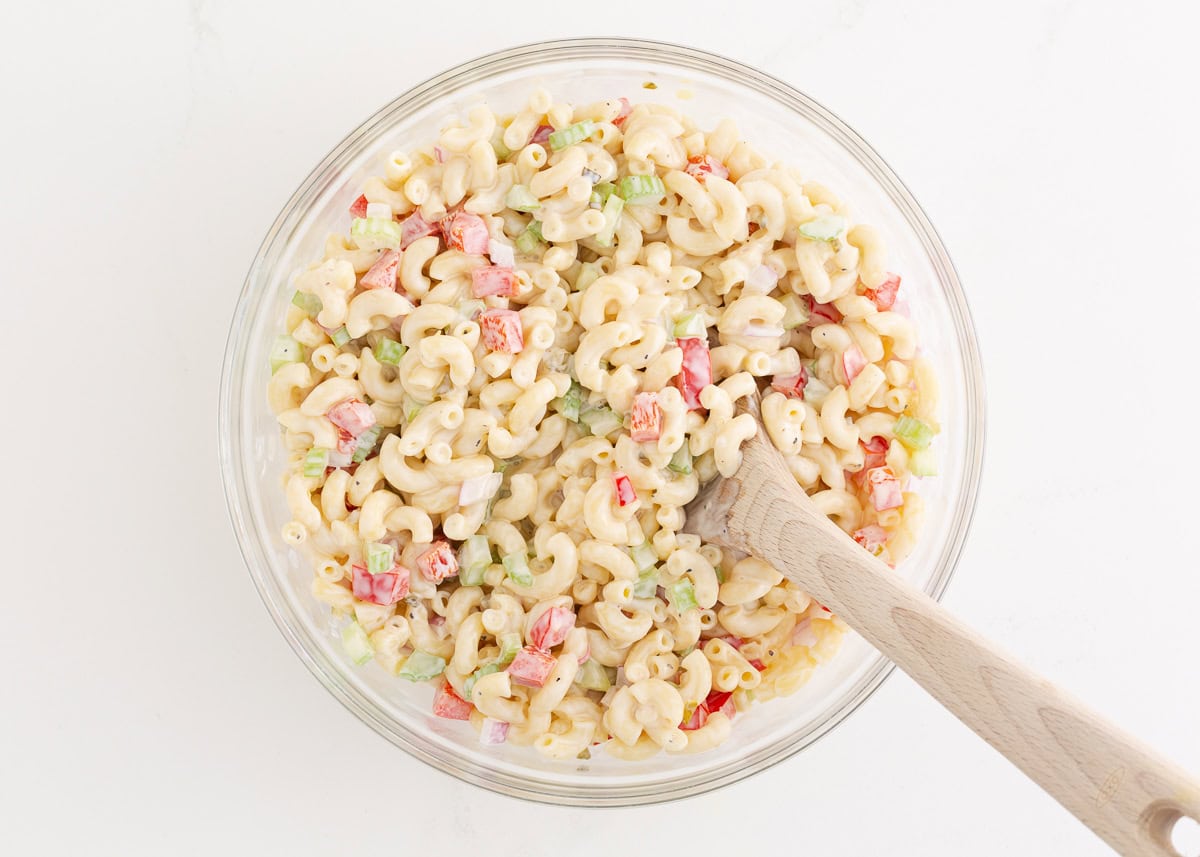 Stirring macaroni salad.