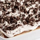 Assembled ice cream sandwich cake in a white pan.