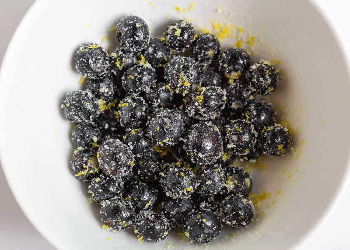 Sugar and blueberries in bowl.