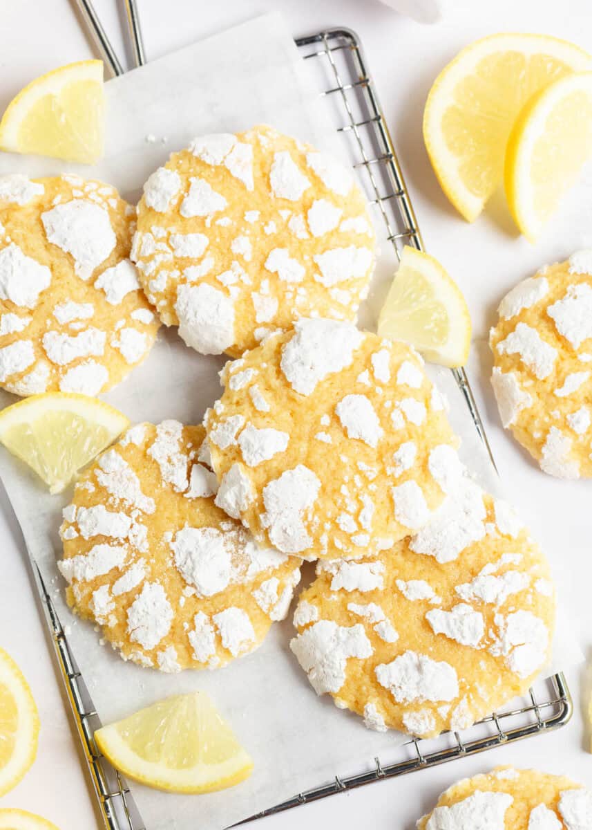 Lemon crinkle cookie recipe on parchment covered bakers rack.