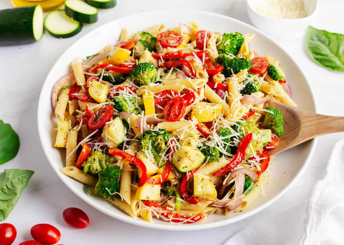 Pasta primavera assembled with Parmesan cheese.