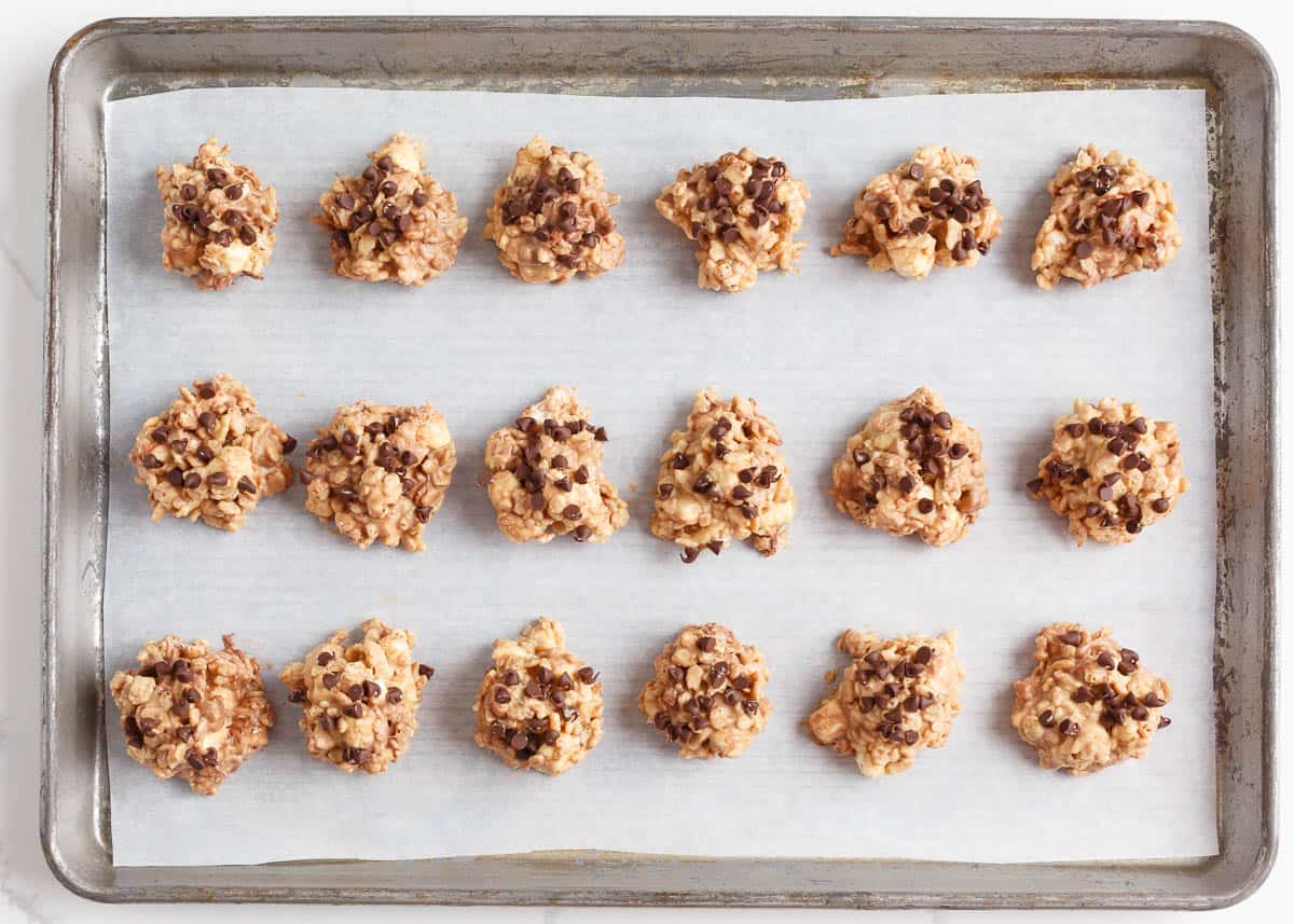 Parchment covered baking sheet with avalanche cookies.