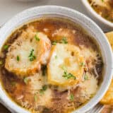 French onion soup in a white bowl.