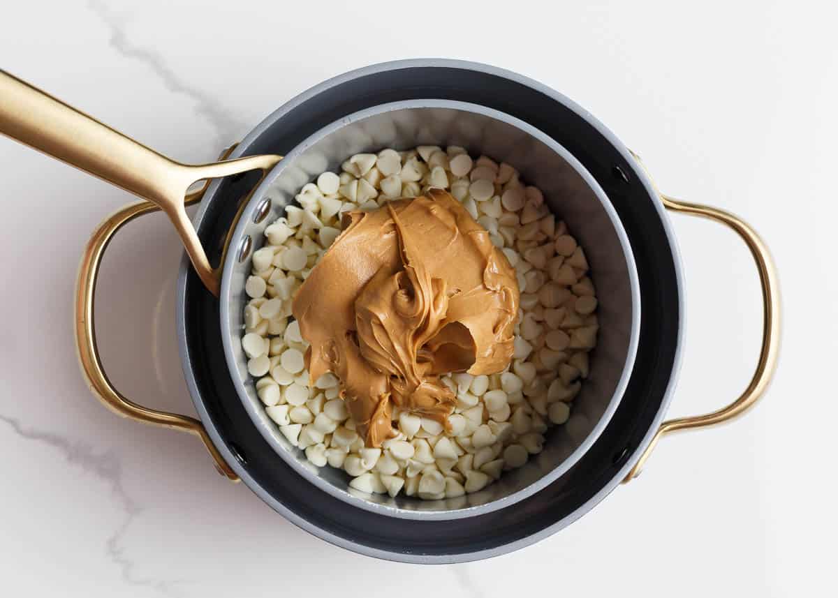 White chocolate chips and peanut butter in a pot.