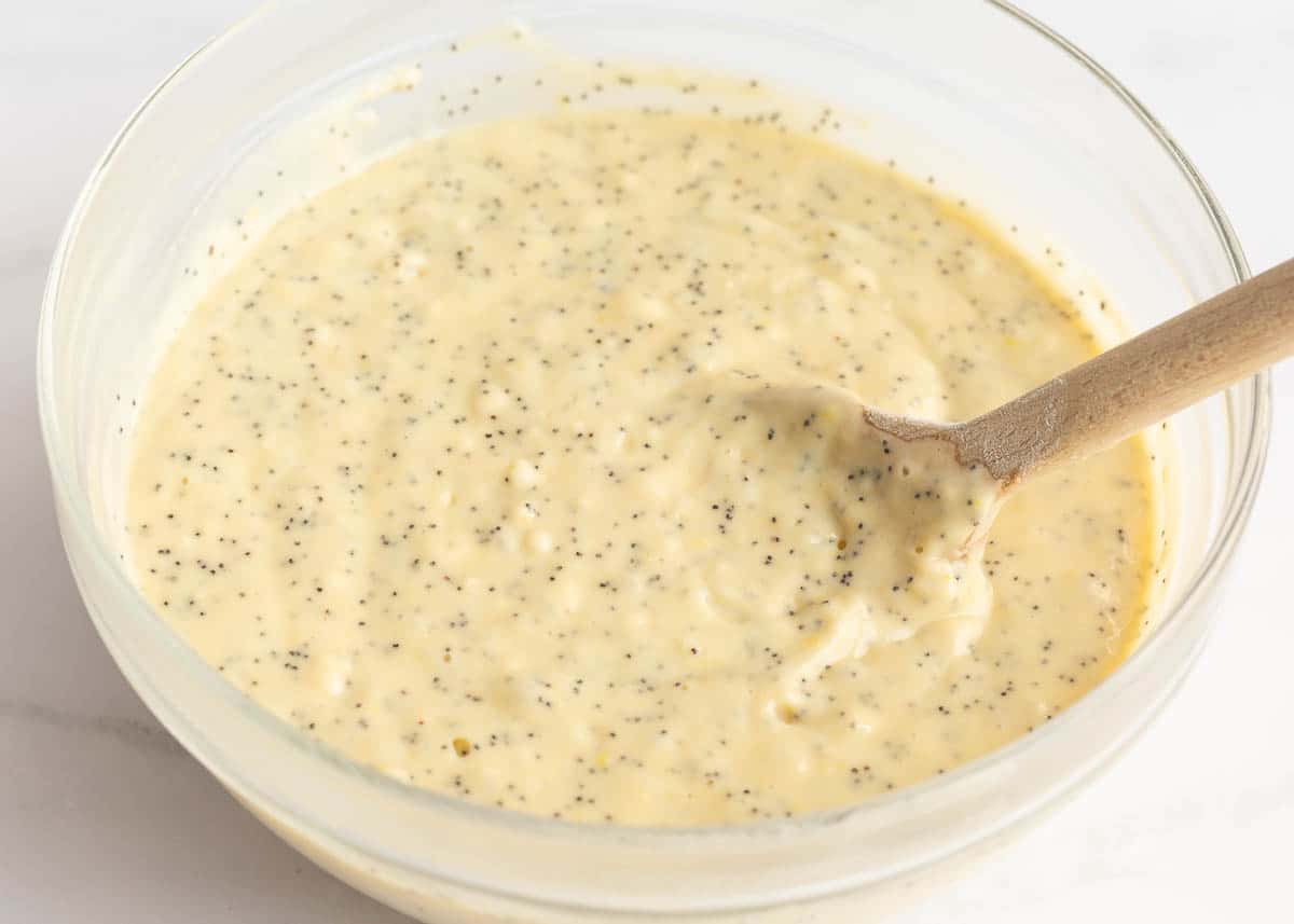 Lemon poppy seed bread batter in a bowl with wooden spoon.