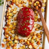 Sheet pan meatloaf with potatoes on a rimmed sheet pan.