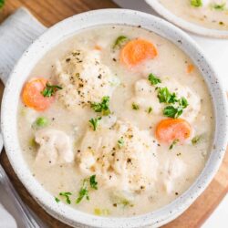 Chicken dumplings soup in a bowl.