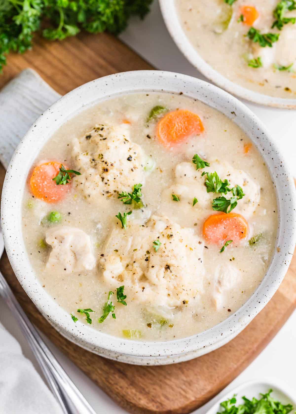 Chicken dumplings soup in a bowl.