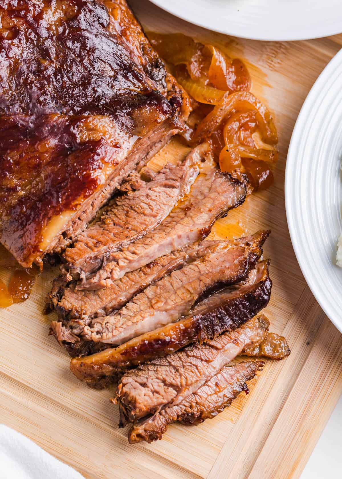 Sliced brisket on a cutting board.