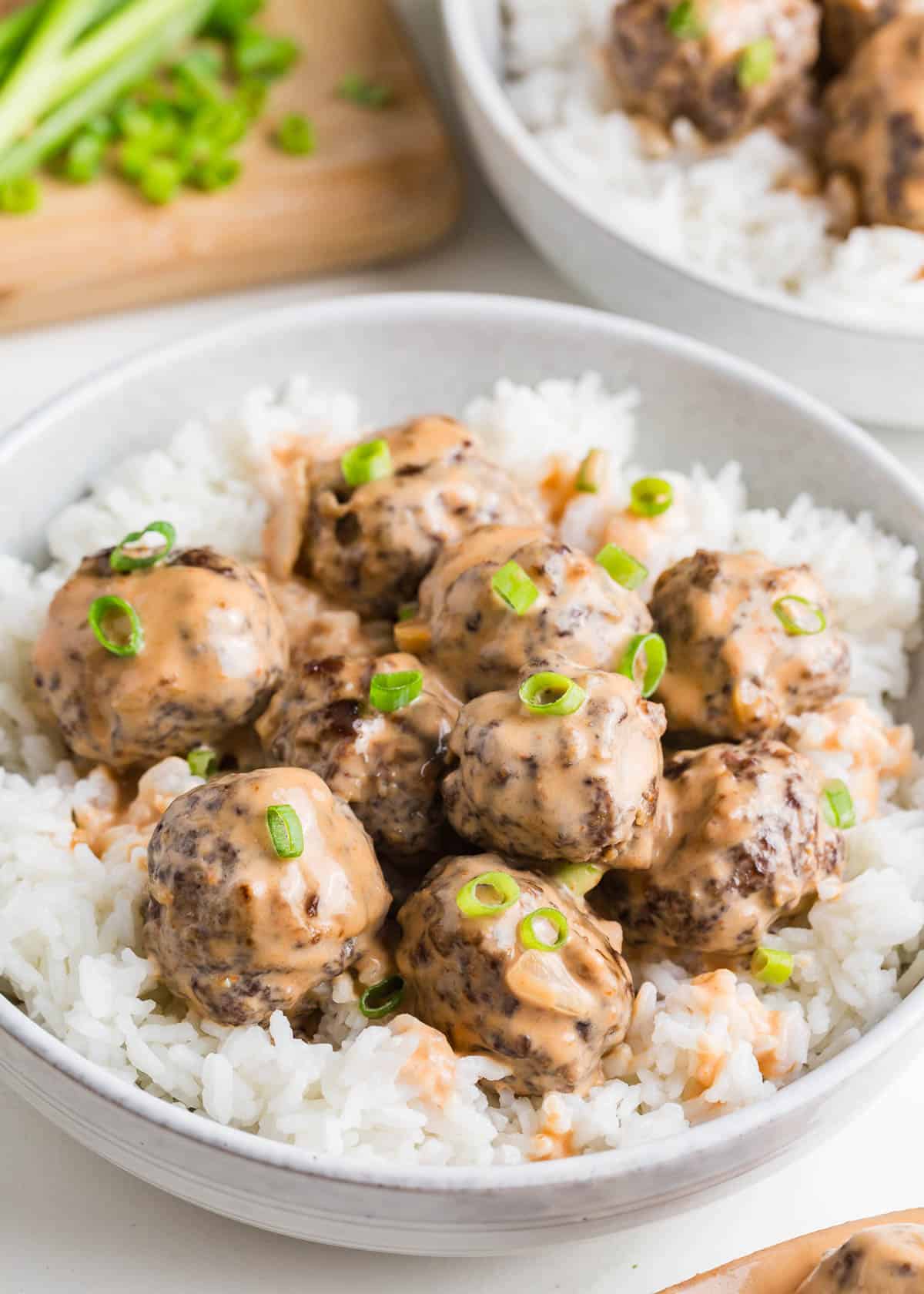 Firecracker meatballs in a bowl with rice.