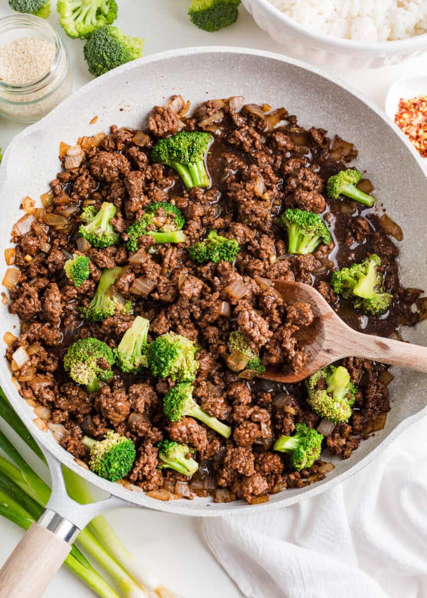 Cooking ground beef and broccoli in a skillet.