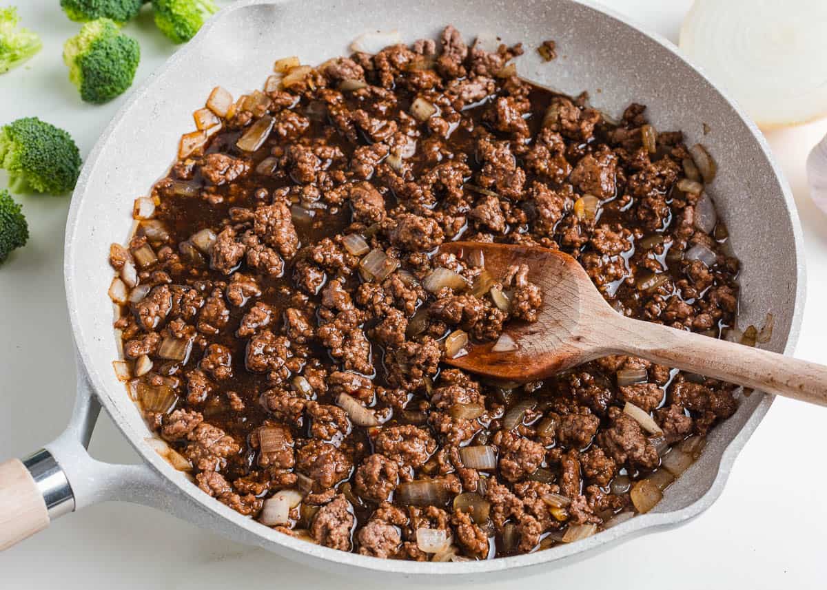 Ground beef cooking in a skillet.