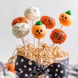 Halloween cake pops in a glass container.