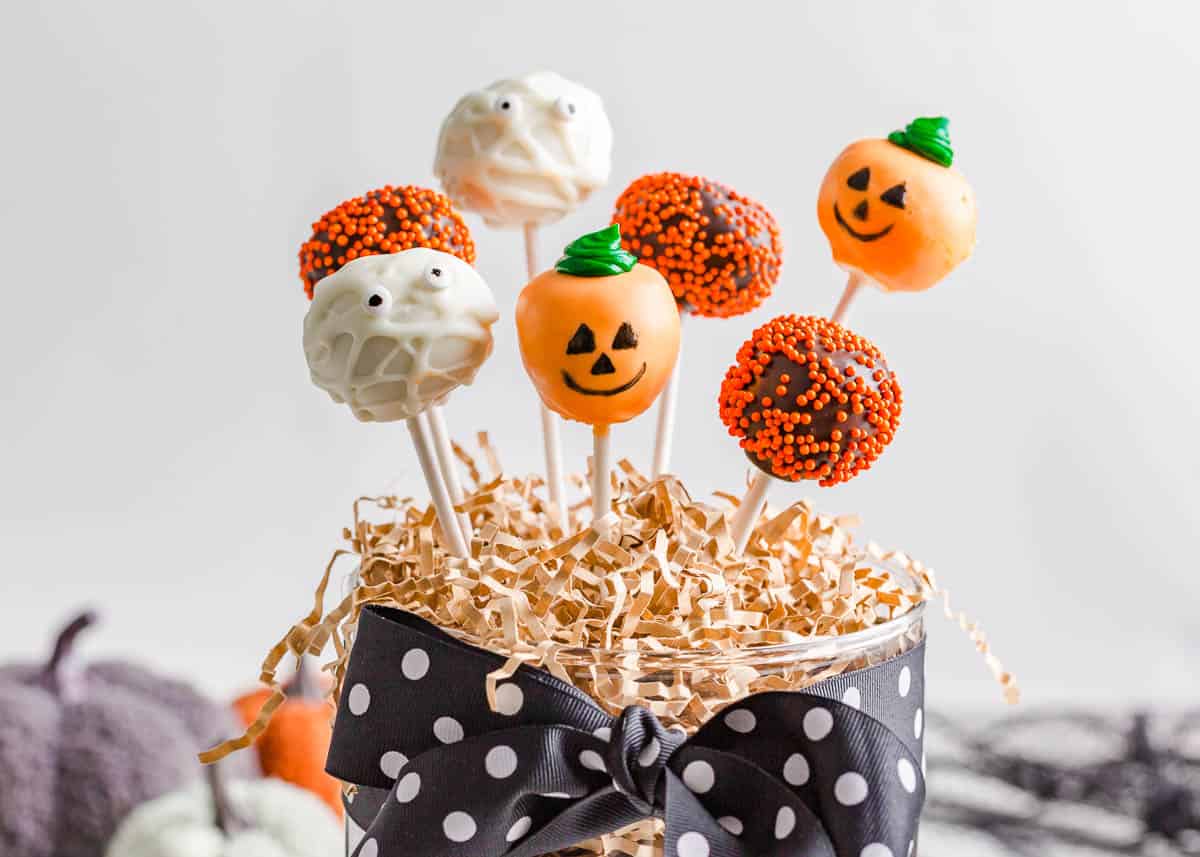 Halloween cake pops in a glass container.