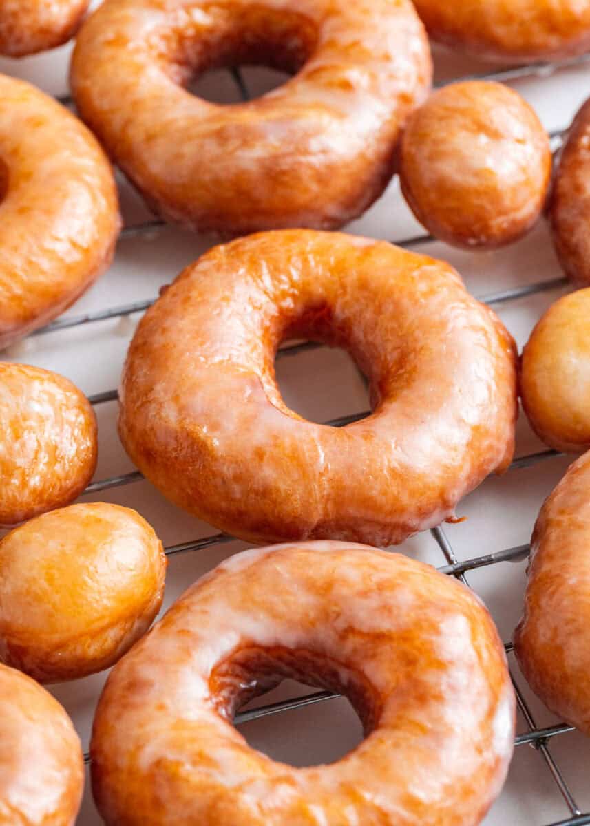 Homemade donuts on a wire baking rack.