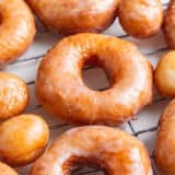 Homemade donuts on a cooling rack.