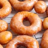 Homemade donuts on a cooling rack.