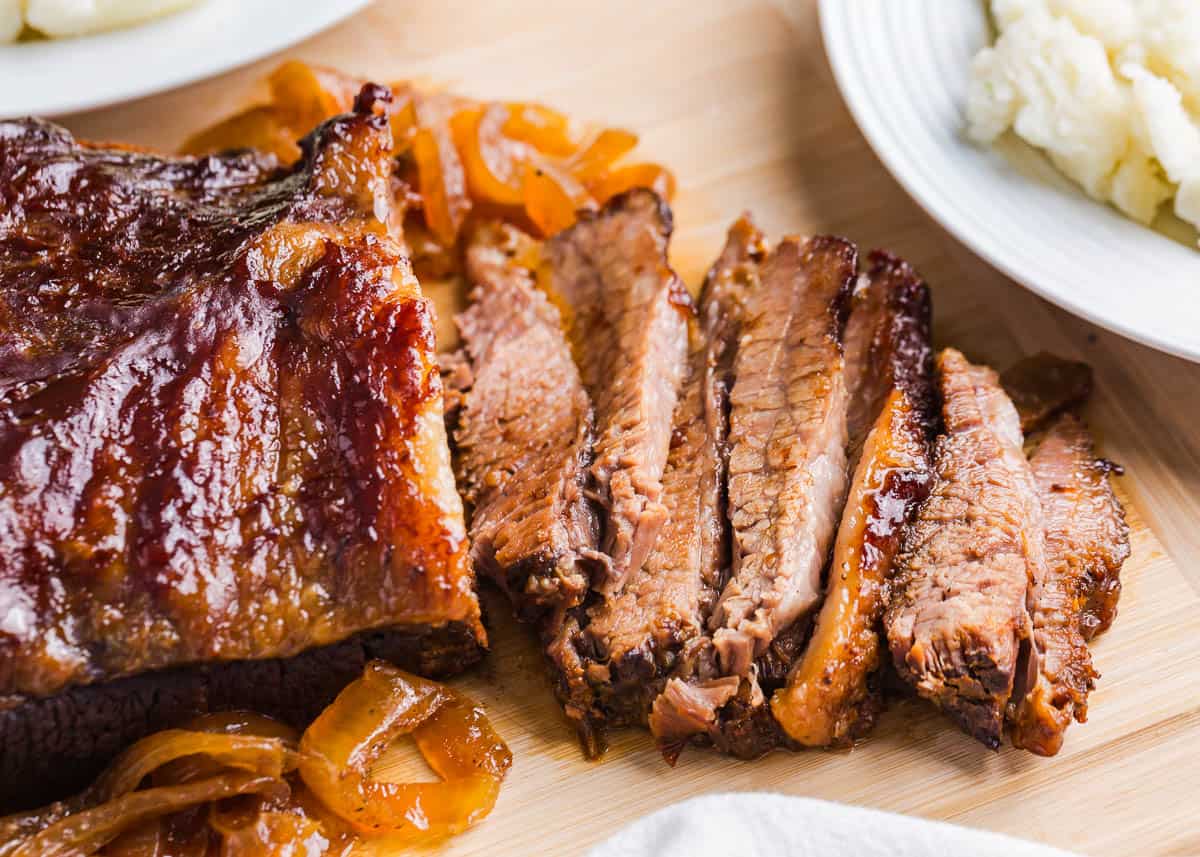 Sliced brisket on a cutting board.