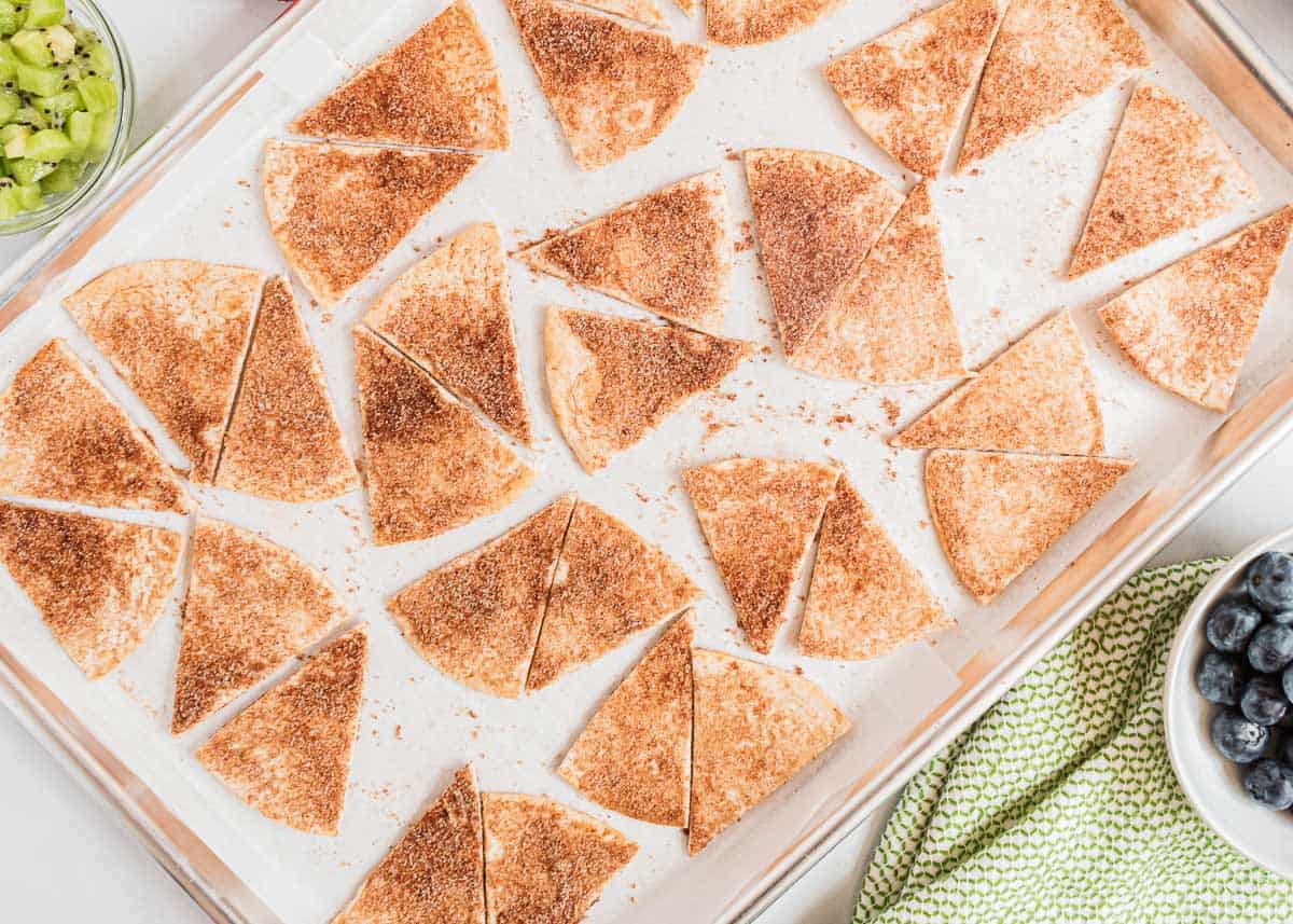 Cinnamon tortilla chips on a pan.