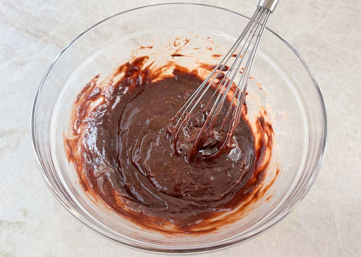 Mixing nutella brownie batter in a bowl.