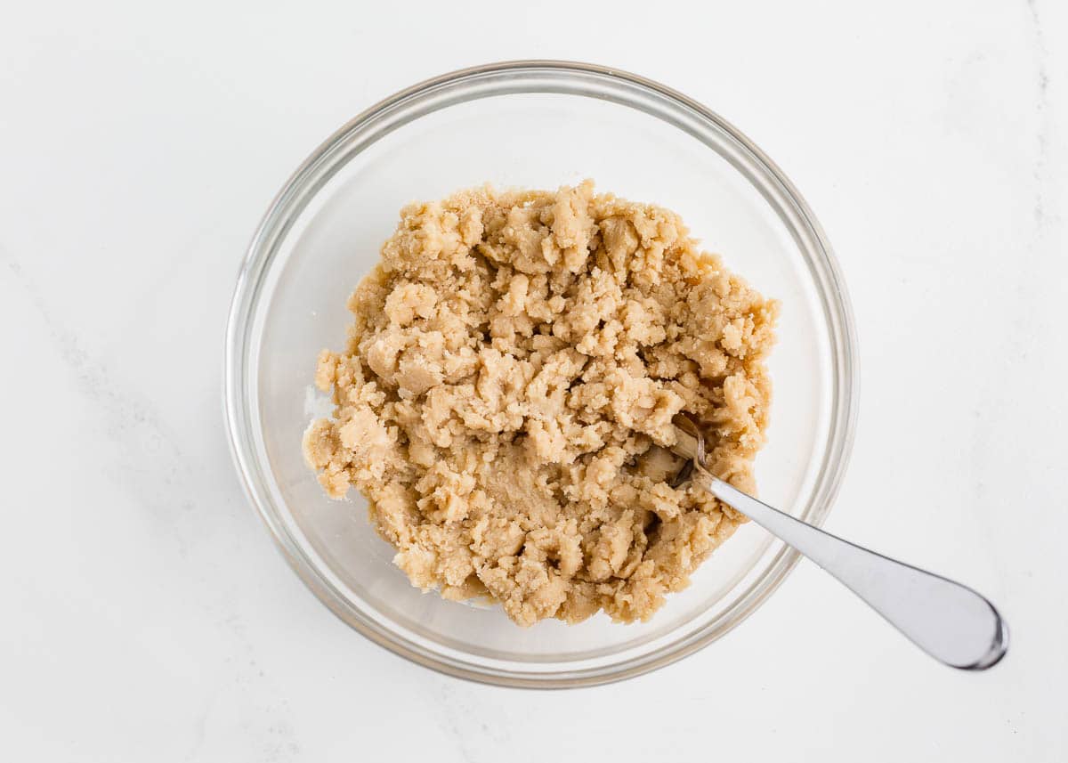 Mixing crumble in a bowl.