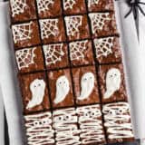 Halloween brownies on a black platter.