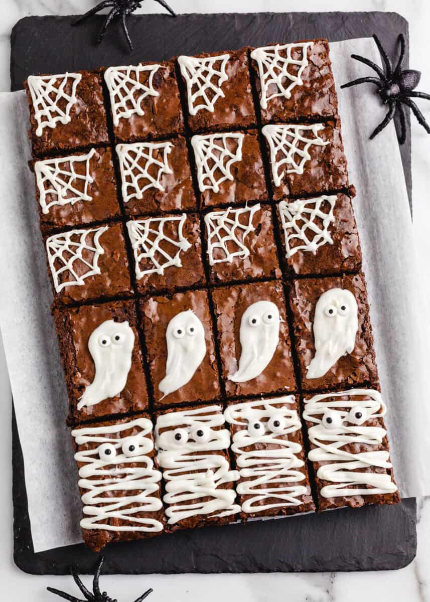 Halloween brownies on a black platter.