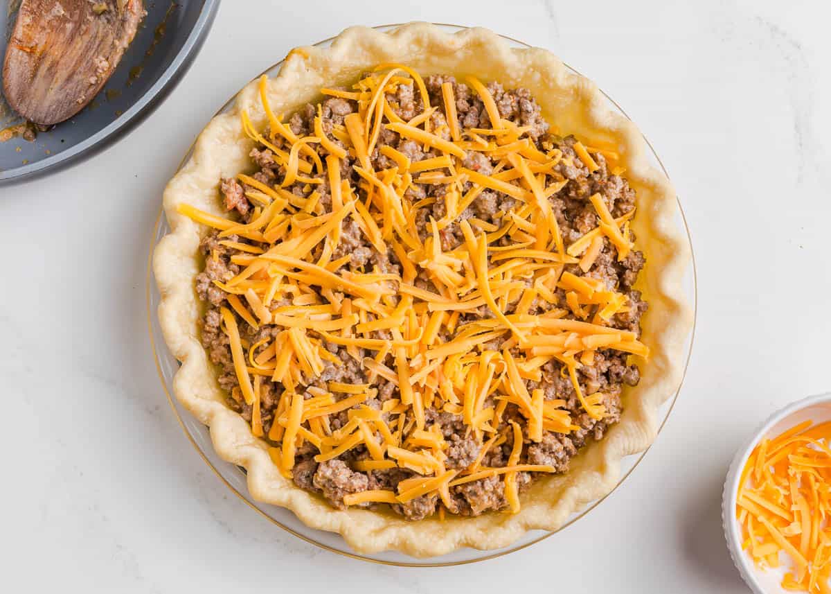 Showing how to make taco pie.