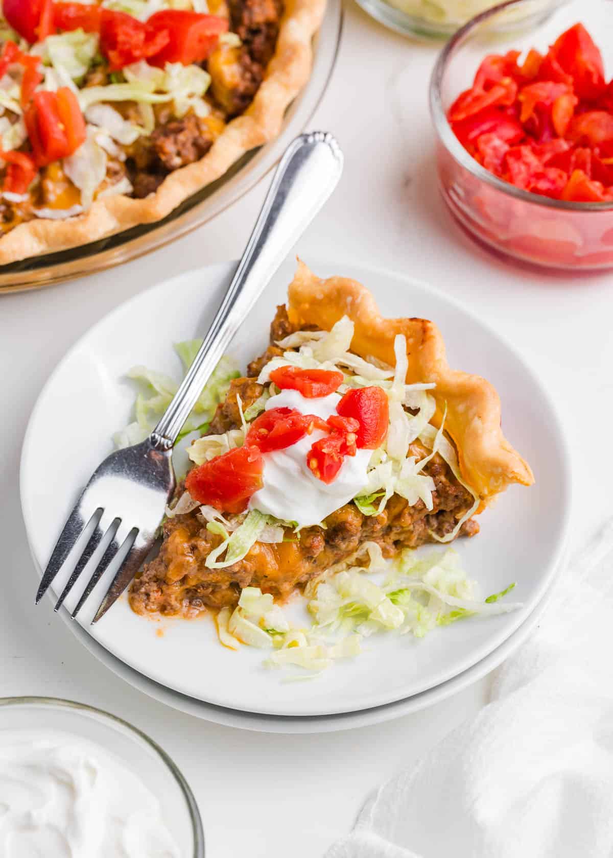 Slice of taco pie on a white plate.