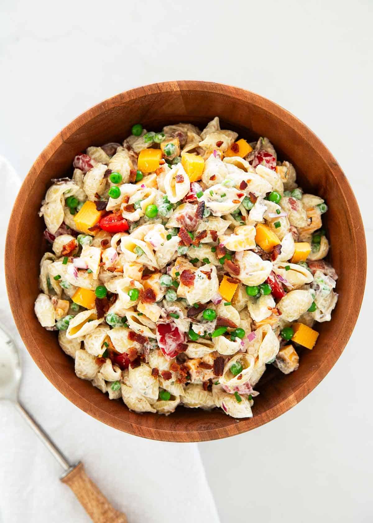 Bacon ranch pasta salad in a wooden bowl.