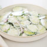 Creamy cucumber salad in a bowl.