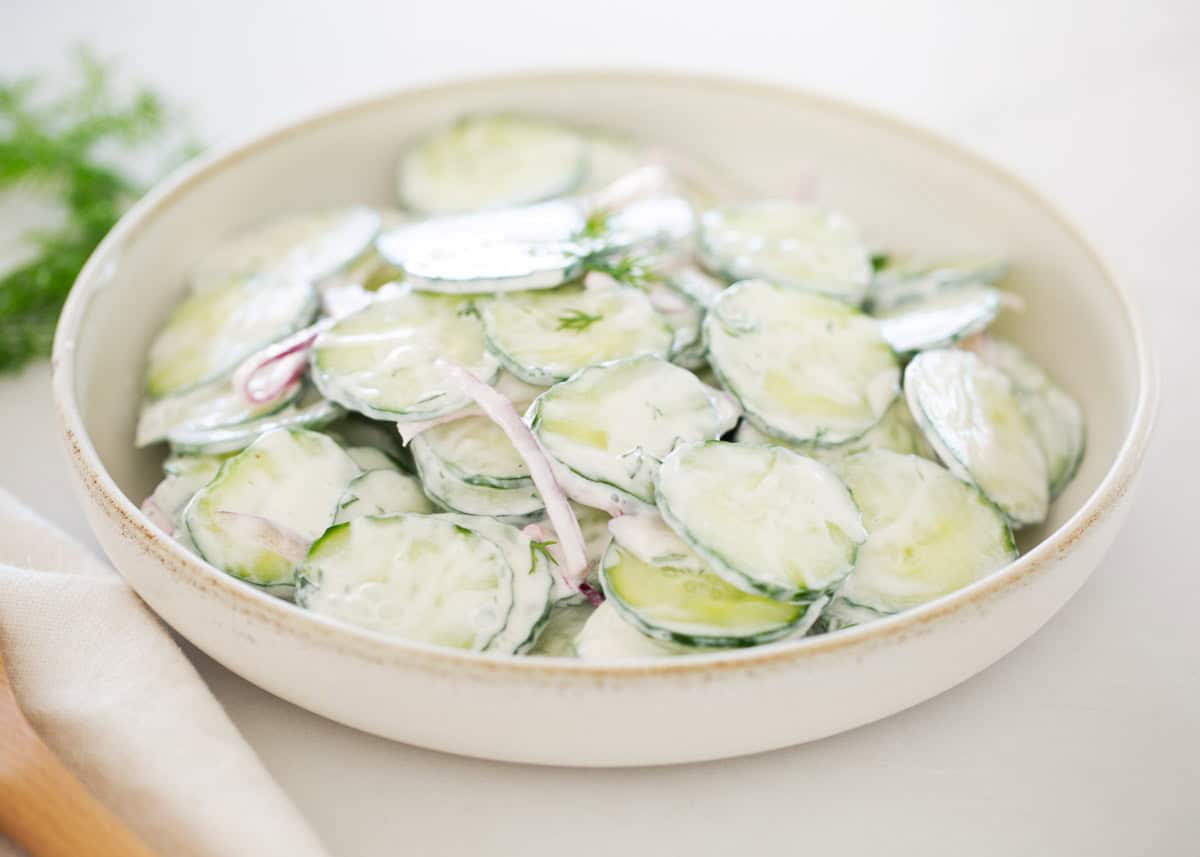 Creamy cucumber salad in a bowl.