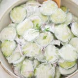 Creamy cucumber salad in a bowl.