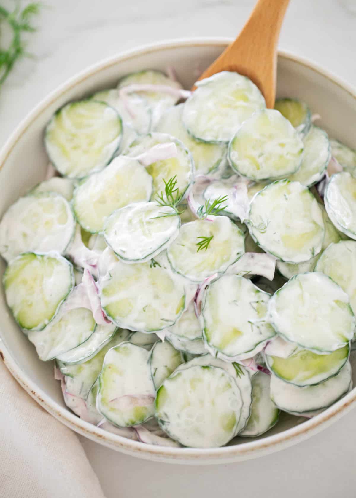 Creamy cucumber salad in a bowl.