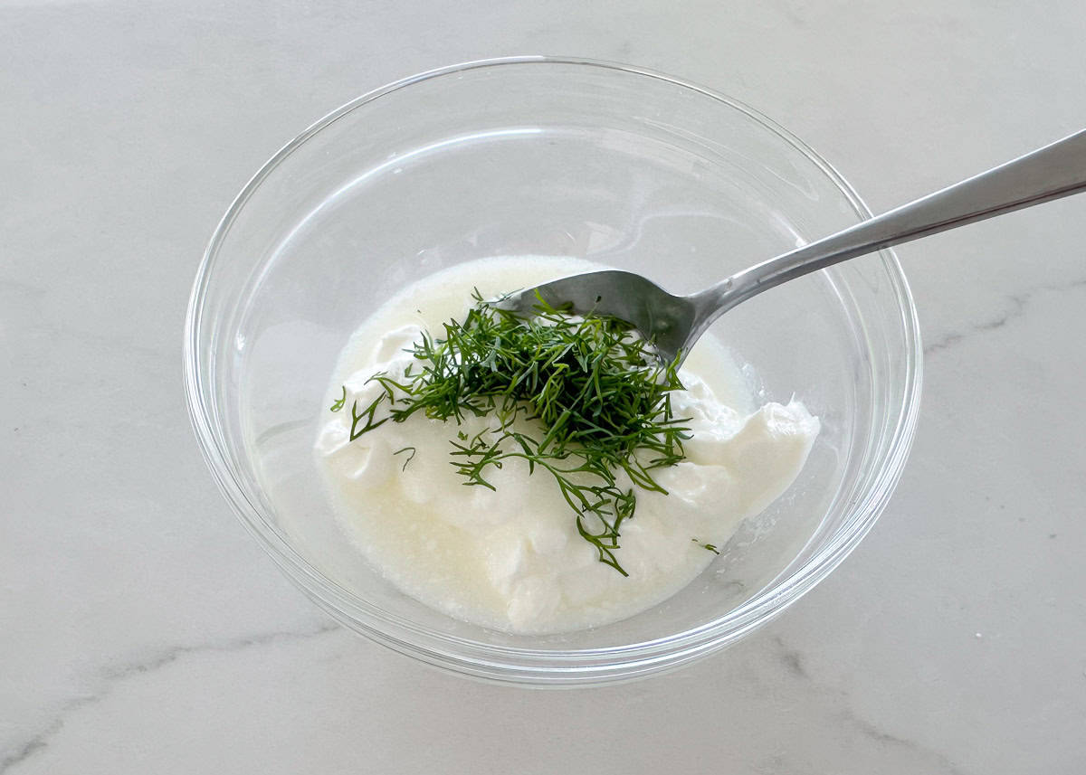 Mixing cucumber salad dressing.